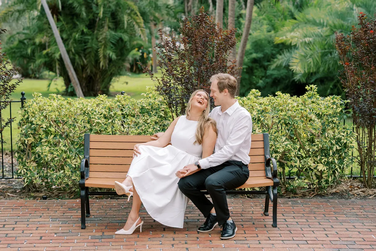 Madison and Tyler laughing together on a park bench in Tampa
